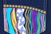 Denim Pocket design with nailheads and colorful embroidery.